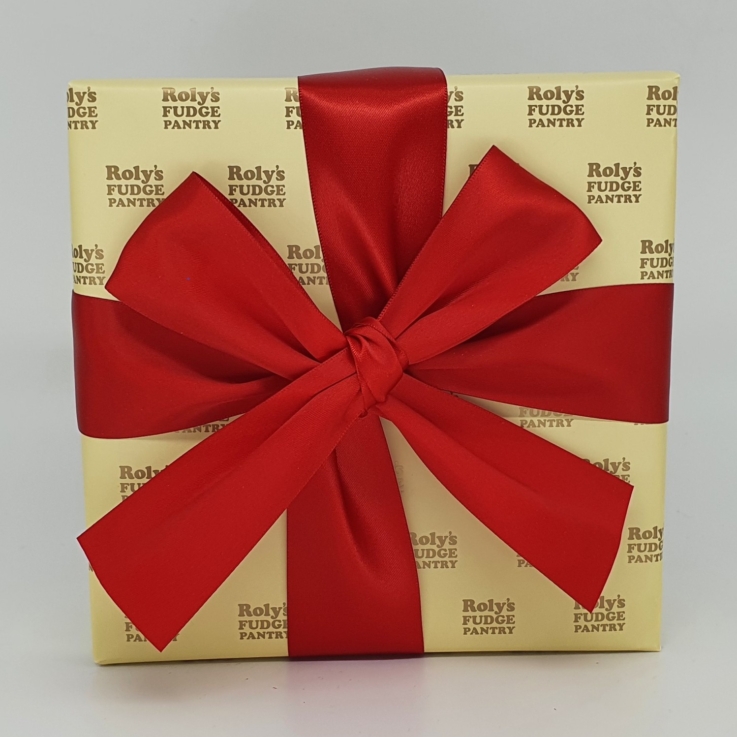 A box of fudge wrapped in cream wrapping paper